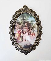 Front view showing entire ornate brass frame and print