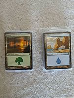 Front view of both sealed land packs: Forest and Island