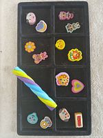 Overall tray view showing 12 erasers plus twisted stick