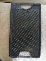 Full view of ridged grill side with handles visible