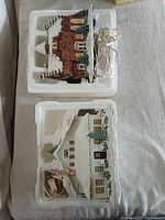 Both ceramic houses in Styrofoam packaging with cords