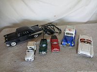 All items grouped: phone plus six die-cast vehicles