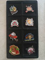 All eight trading pins in tray for overall view