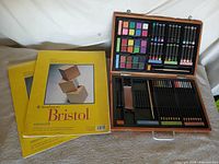 Art set open with supplies and two Bristol pads visible