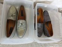 Both pairs of loafers in plastic bins