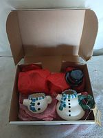 Set in original box with tissue showing teapot, cup, lid
