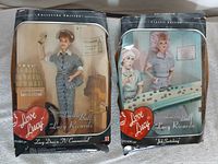 Front view of both boxed dolls
