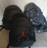 All three backpacks standing upright