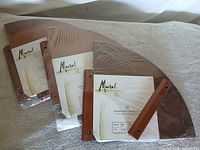 Three sealed Mural corner shelves showing fronts and labels