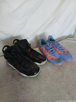 Both pairs of shoes side by side on surface