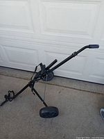 Side view of folded ProSource JR 890 pull cart showing overall form and wheels