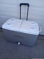 Overall view of cooler closed showing wheels, handle, drain plug