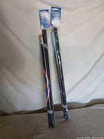 Both sealed poster hanger kits side by side