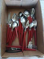 Boxed view of entire red-handled flatware assortment