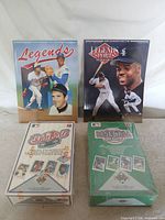 Group shot of two sealed Upper Deck boxes and two Legends magazines