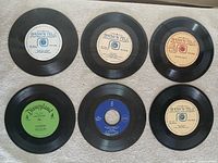 Six 7-inch records laid out, labels visible