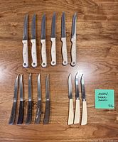 All 14 steak knives laid out showing handle variations and blade edges