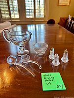All seven clear glass serving pieces on tabletop