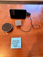 Echo Dot, Echo Show 5, power adapter displayed on table