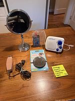 Group shot of all five items: clipper, Wahl oil, vanity mirror, 10× mirror, shower radio