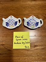 Pair of Andrea by Sadek porcelain spoon rests on wooden surface