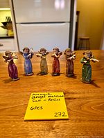 Front view of all six Artmark resin angel musician figurines on tabletop