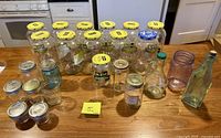 All jars and bottles arranged on countertop showing quantity, sizes, colors, and lids
