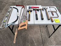 Top view of all nine hand tools laid out on folding table