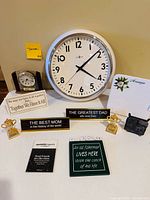 Overall view showing wall clock, mantel clock, plaques, trophies, magnet and cast iron trivet