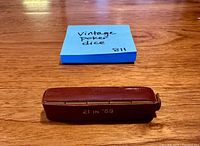 Brown leather dice case stamped 21 IN '69 displayed closed