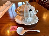 Tureen with lid on underplate and ladle displayed