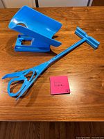 Sock slider base and puller rod displayed on table
