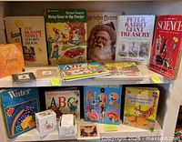 Shelf holding ten hardcover children's books listed
