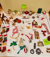 assorted Christmas ornaments laid out on white surface