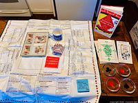 All items laid out: vinyl bridge cover, cards, score pad, books, mug, napkins, ashtrays