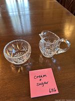 creamer and sugar bowl on table, side view