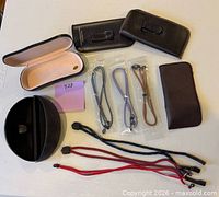 Top-down view showing all 12 eyewear accessories—cases, pouches and cords