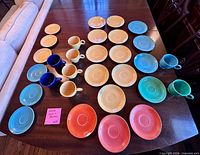 Front view of all 30 Fiesta pieces arranged by colour on table