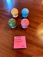 Top view of four colored Fiesta shakers on table