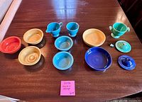 All 12 Fiesta ceramic pieces laid out on table