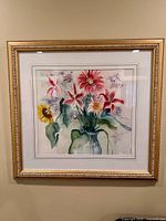 Full view of framed floral artwork in gold frame