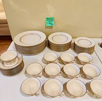 Stacks of plates and cups showing Somerset gold band pattern and overall quantity
