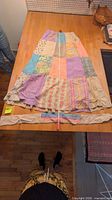 Skirt laid flat with measuring tape and separate sash visible