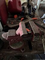 Red cast iron Great Neck bench vise on workbench