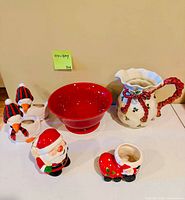All six ceramic Christmas items arranged on table