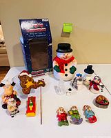 Overall lot showing singing snowman, box and assorted holiday figurines and ornaments