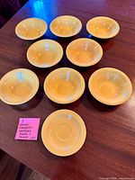 Top view of eight yellow oatmeal bowls and one saucer