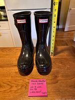 Front view of both boots with measuring tape for shaft height and size note