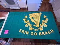 Full view of flag showing Erin Go Bragh harp, shamrocks and text