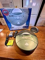 Full lot showing Roomba vacuum, dock, adapter, remote, battery, and box